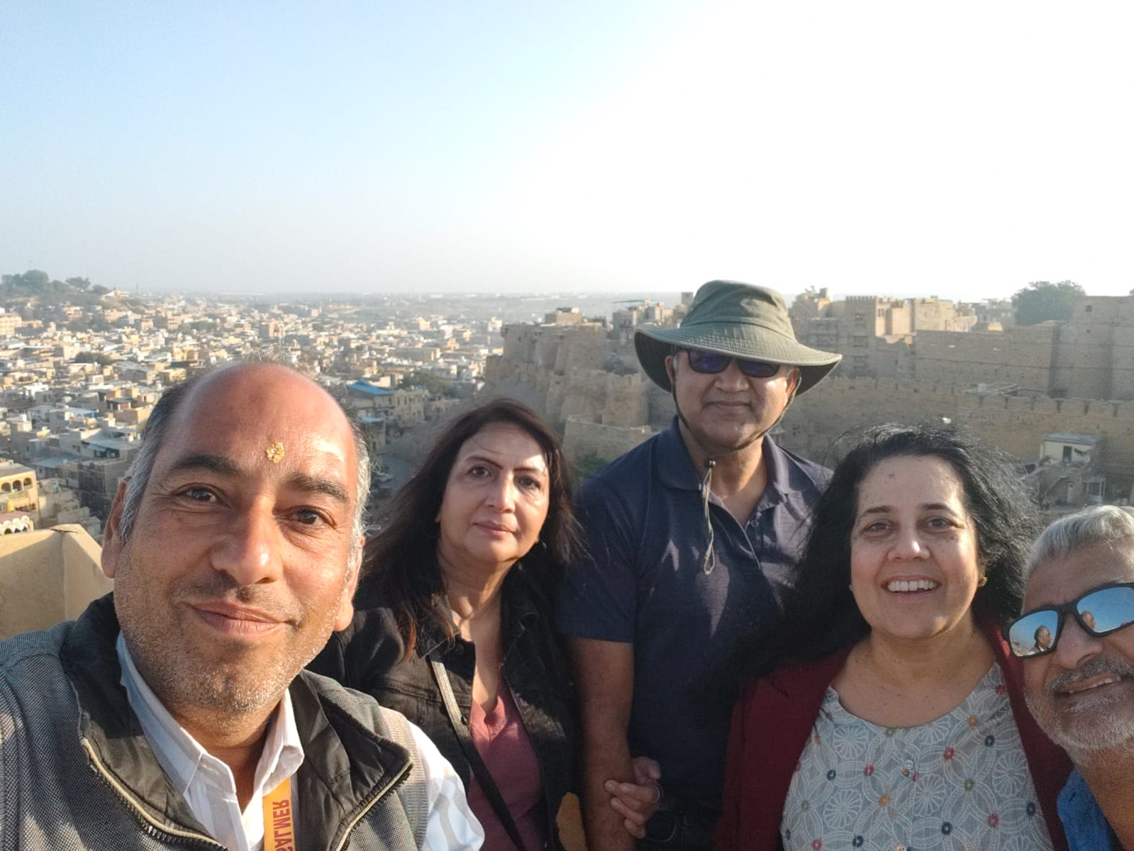 Travellers overlooking the city of Jaisalmer from an elevated viewpoint.